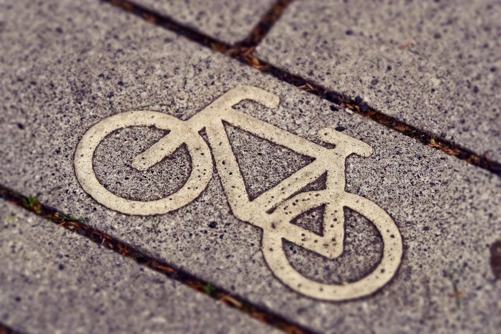 Bicycle path sign embedded in pavement