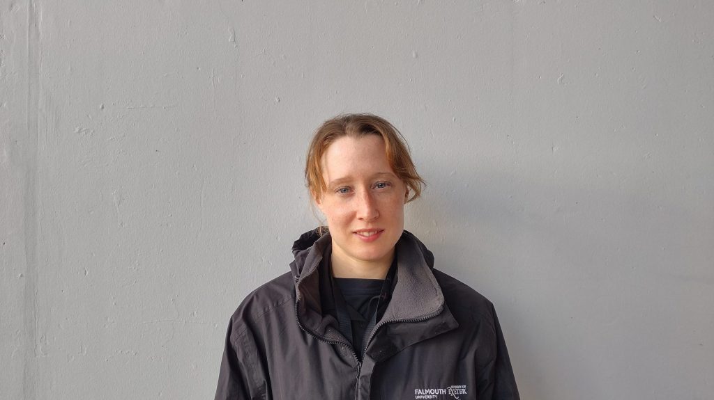 Photograph of staff member in front of a blank wall