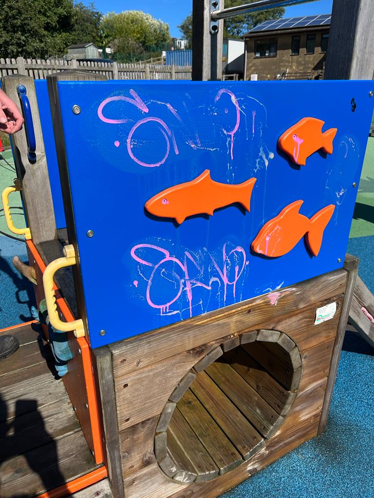 Playground equipment covered in graffiti