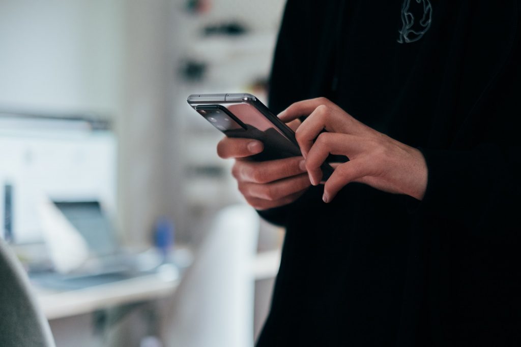 Person using mobile phone touch screen