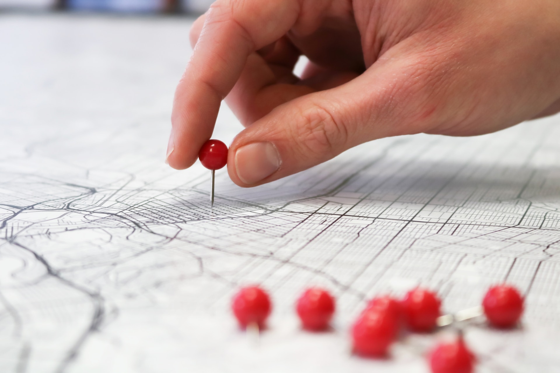 Pins being added to a paper map