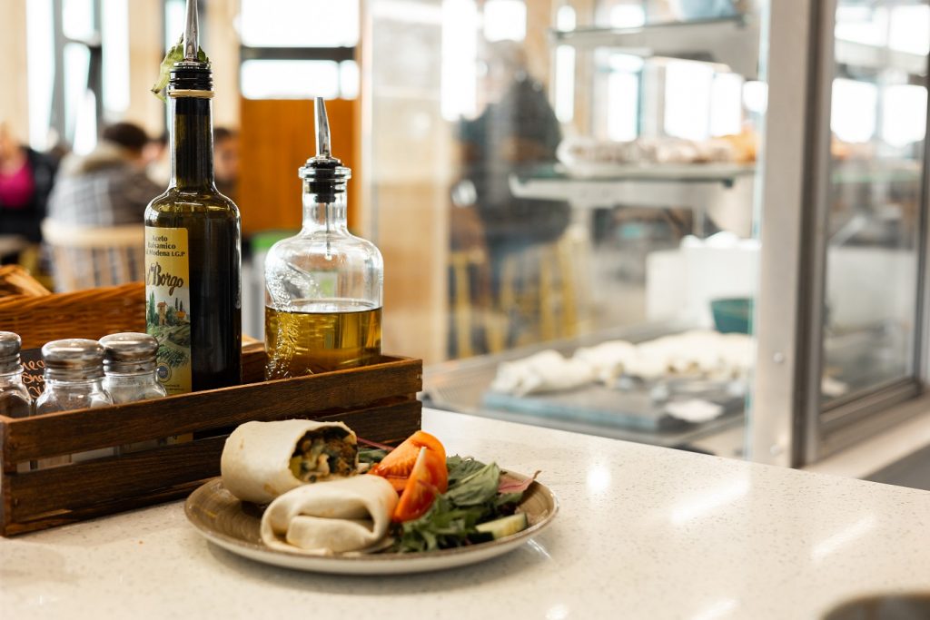 The service counter showcasing a vegetarian wrap on a plate at the Sustainability Cafe on Penryn campus.