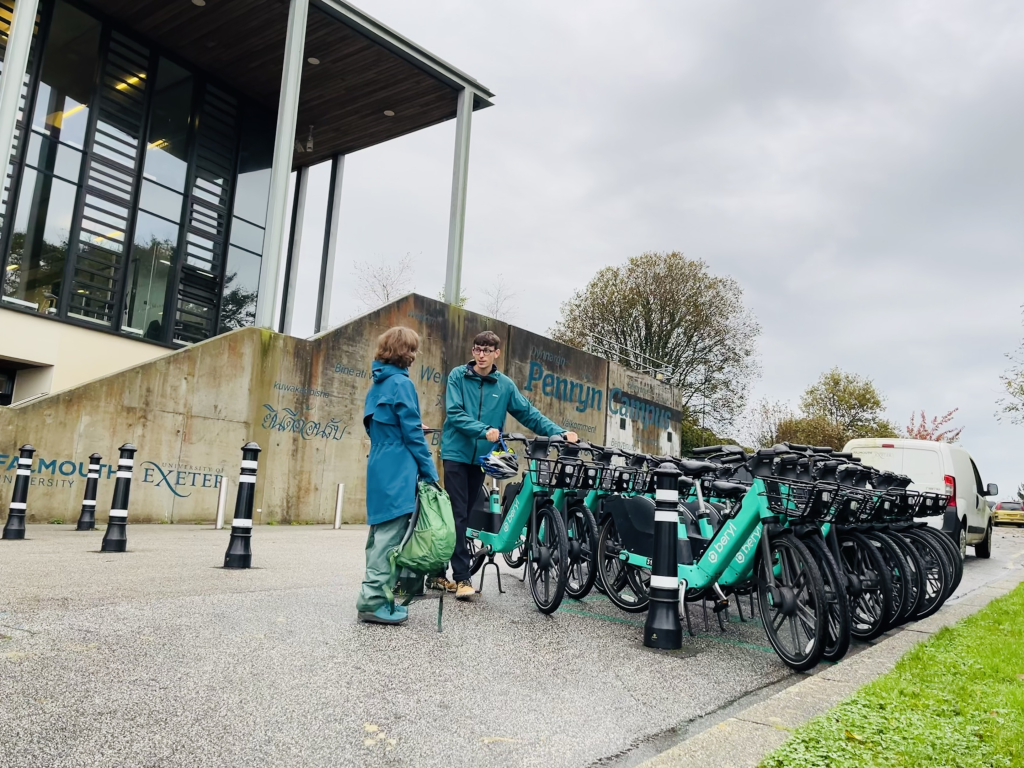 Image of the outside of the Exchange building at Penryn university campus, with bikes and a van parked outside.