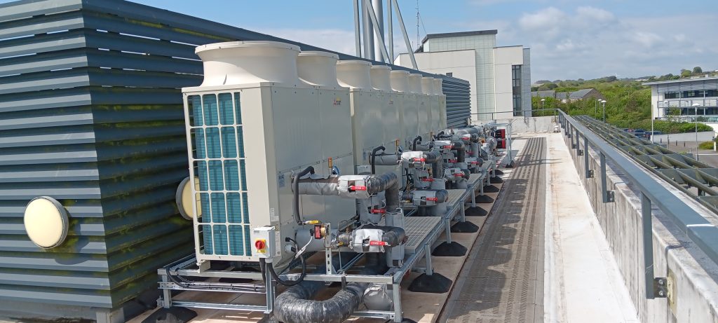 Photo of the four air source heat pumps in position on the roof of the Stella Turk building at Penryn campus.