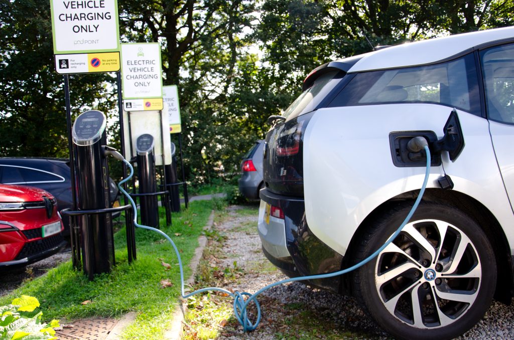 image of a white vehicle plugged into electric vehicle charging point at Penryn campus, car park A