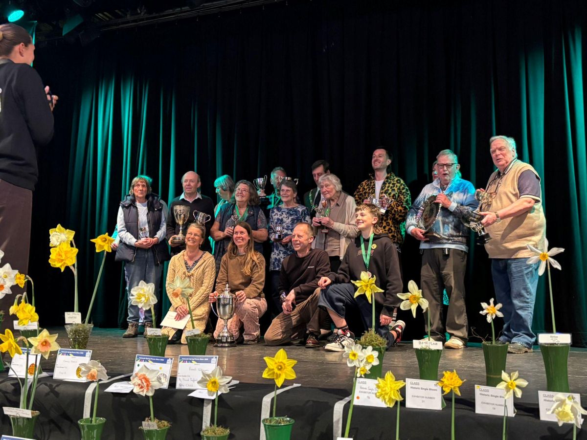 Toby Nenning, Grounds and Gardens Manager at FX Plus with the Shrub Trophy on stage with the other prize winners at the Falmouth Spring Flower Show 2026